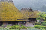 Two Thatched Houses In Rain