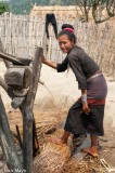 Woman Soaking Grass For Thatch