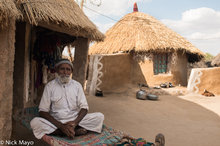 Man Outside His Thatched Bunga