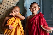 Young Monks Snacking On Watermelon