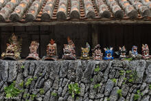 A Row Of Shisa On A Coral Wall