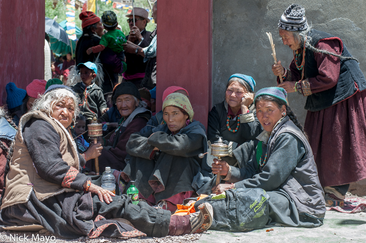 Ladakhi women holding prayer wheels at a religious assembly in Lamayuru.