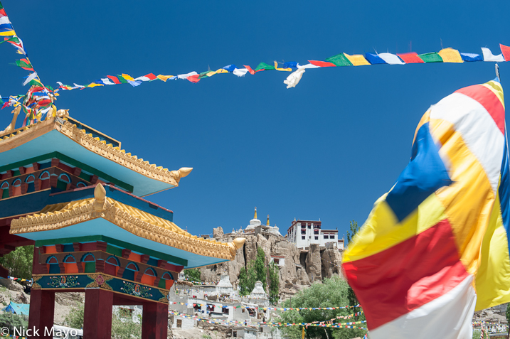 The Lamayuru monastery building and stupas with prayer flags.