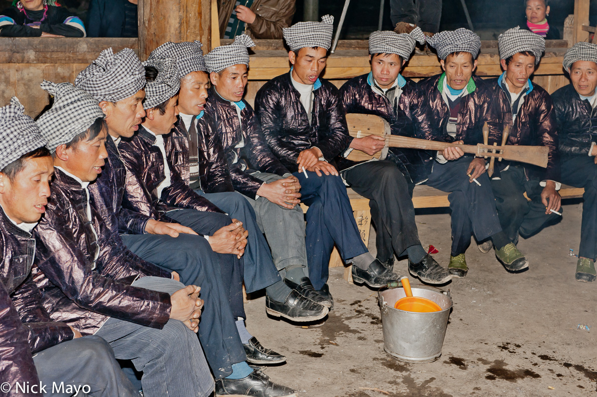 A male Da Ge ensemble singing at a Dong festival in Xiaohuang accompanied by a stringed instrument.