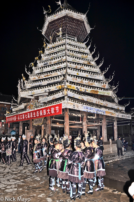 A group of Dong girls waiting by a drum tower to sing at a festival in Xiaohuang.