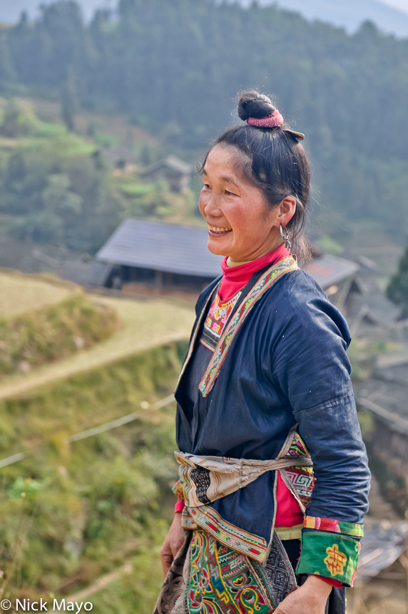 A Miao woman with her hair tied in a top knot in the village of Yangweng.