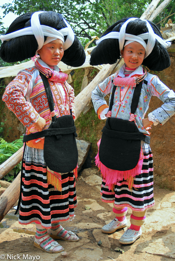 Qing Miao girls from Longee wearing traditional clothes including the full hair piece.