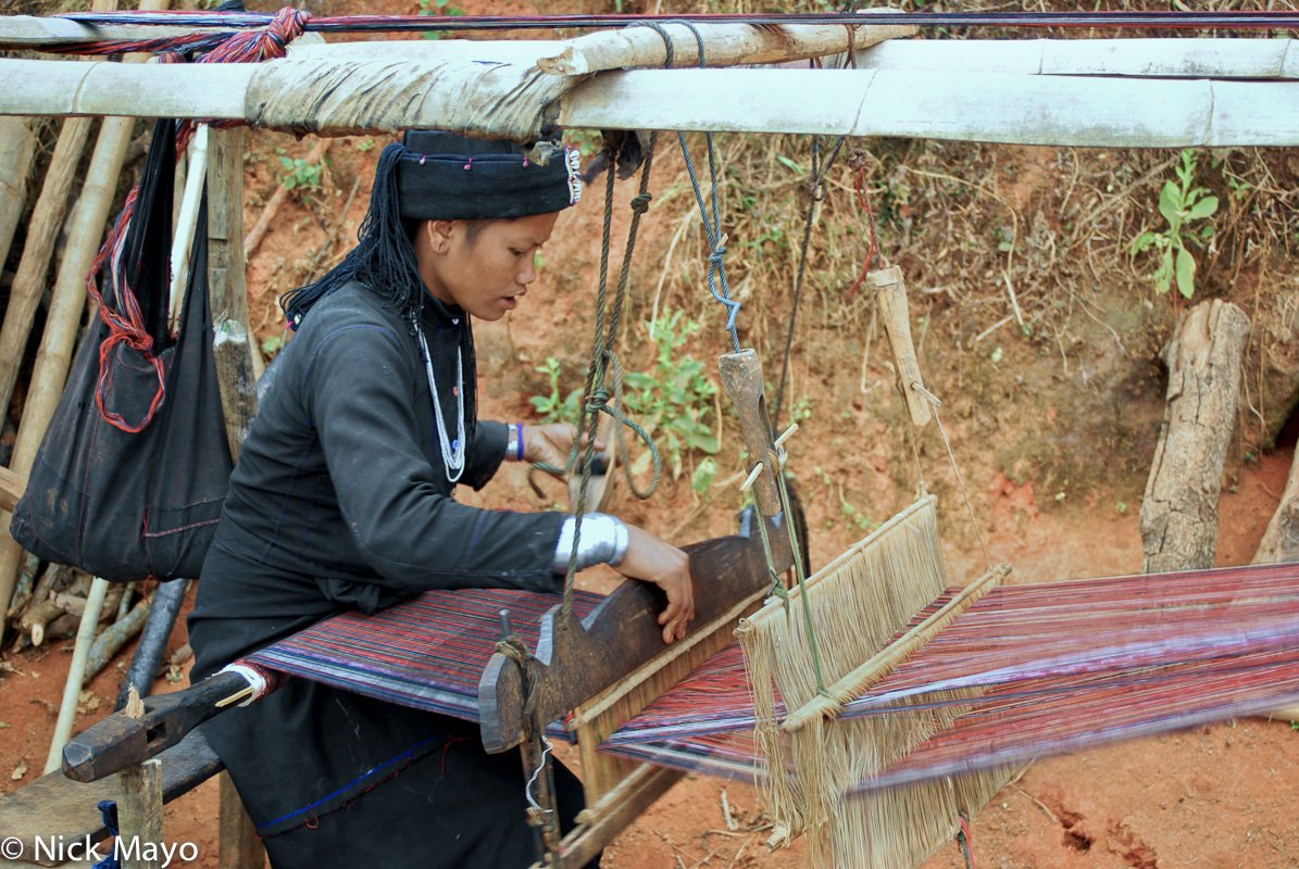 An Eng woman from Ban Lu village weaving on a frame loom.