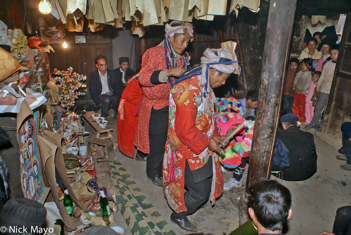 Yao priests (sai mienh) circling the initiates at a dujie coming of age ceremony in Gung Jie Po.