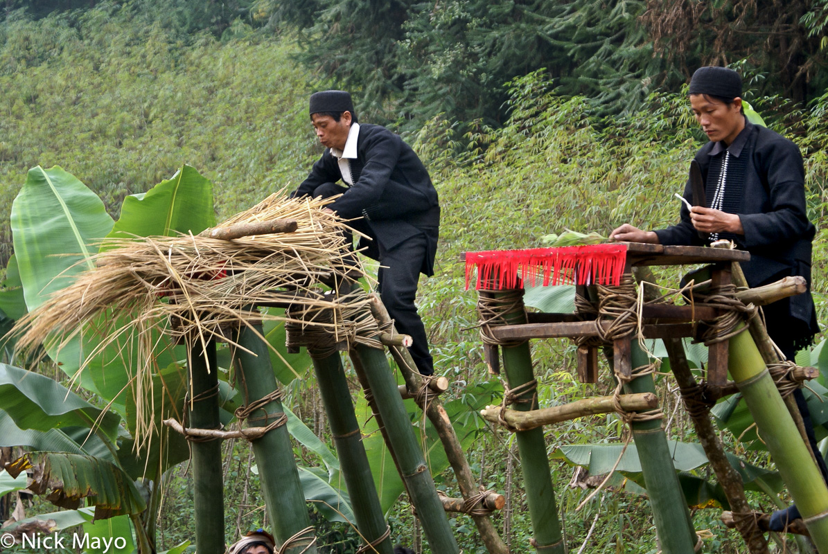 Fathers of initiates at a Yao dujie at Gung Jie Po symbolically cleaning the jumping platforms used in the final ceremony.