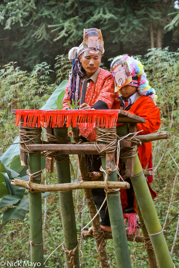 A Yao priest (sai mienh) from Gung Jie Po village performing a purification ritual on a platform used in the dujie ceremony.