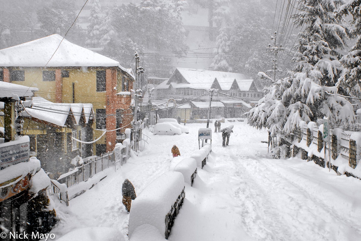 A snow covered street and shops in Dalhousie.