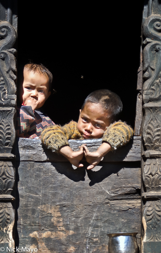 Two children at a window in a house at Kiuri in the Gori Ganga valley.
