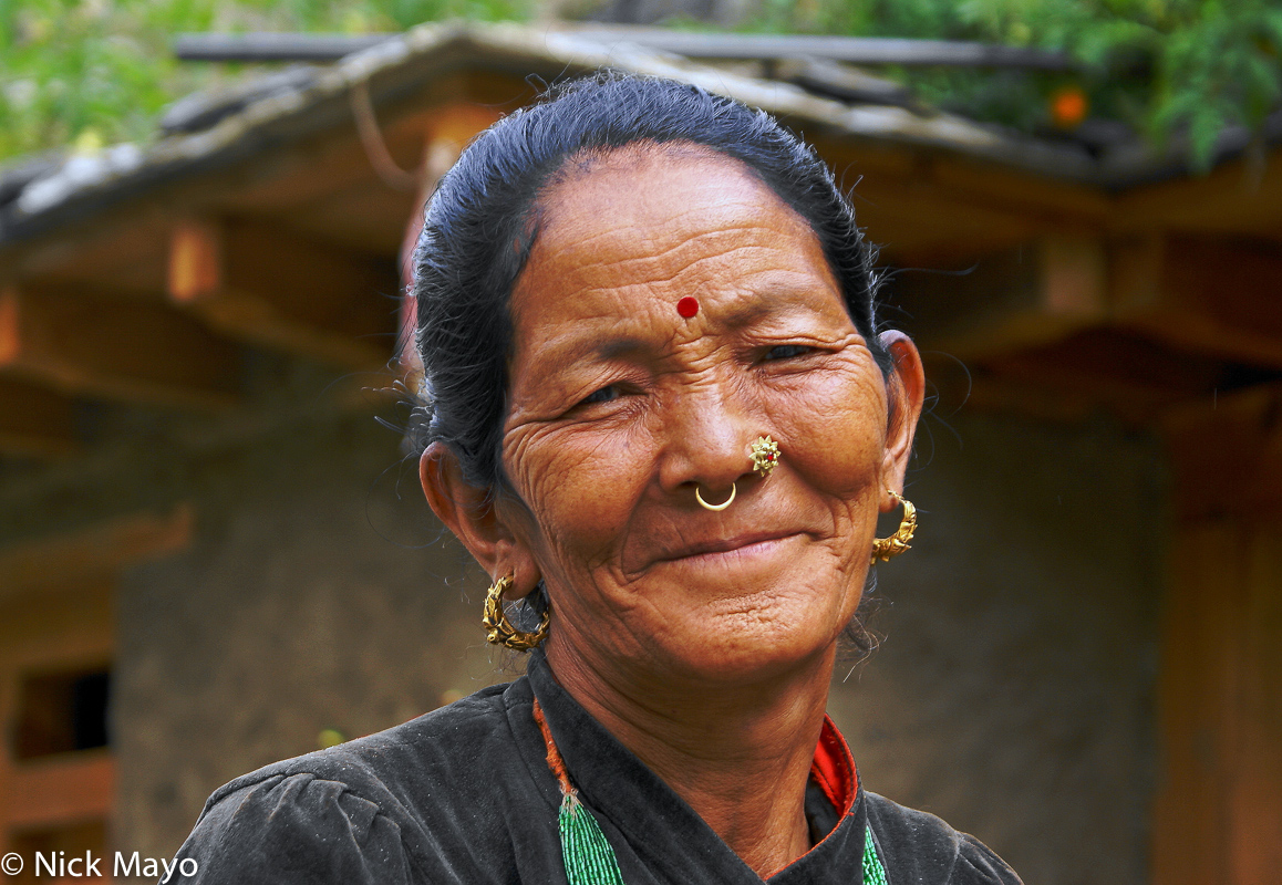 A Magar woman from Tarakot with traditional nose ring, nose stud and earrings.