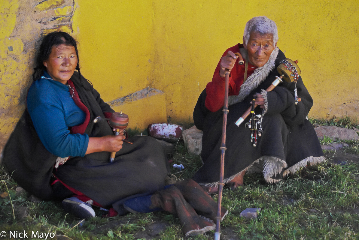 Two Tibetan ladies with prayer wheels and prayer beads in the grounds of the monastery at Sershul.