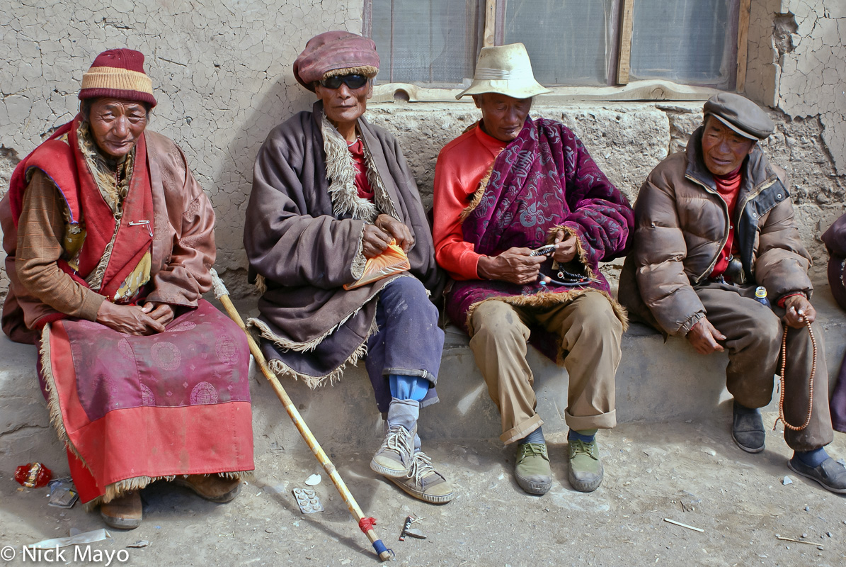 A Tibetan monk and companions with prayer beads reposing at Arikdza.