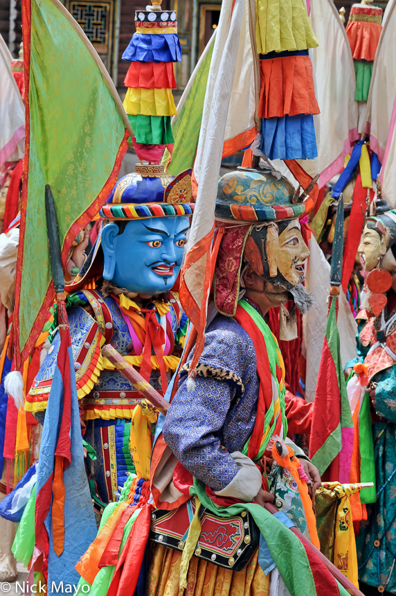 Two masked monks waiting to dance at the Tibetan monastery of Yazer Gon in Manigango.