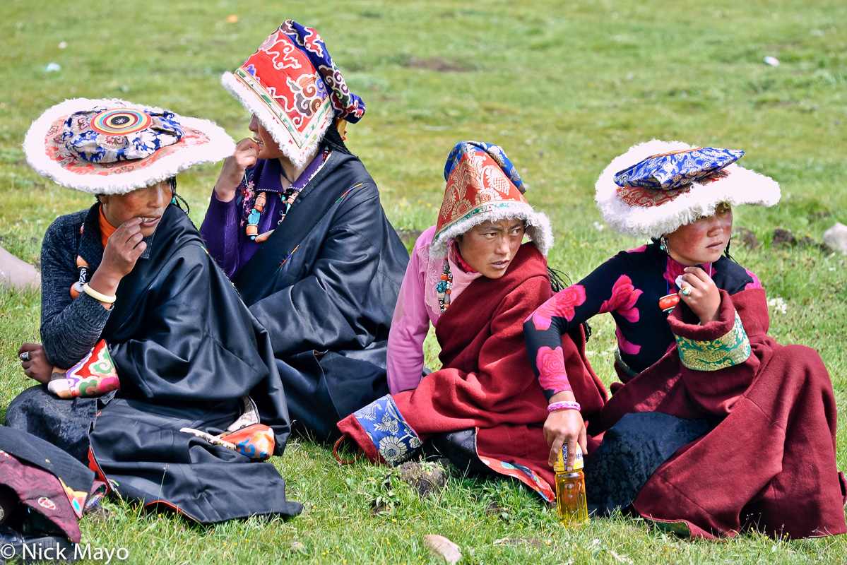 Four Tibetan girls wearing Sershul style hats at a horse festival.