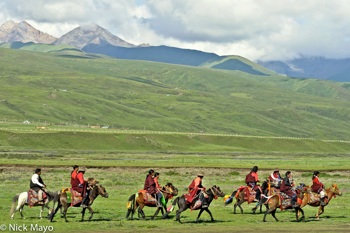 Tibetan horsemen riding to a grassland festival near Manigango.