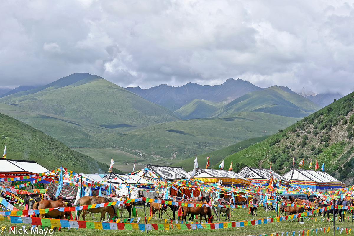 Festival tents and prayer flags at a grassland horse festival near Manigango.