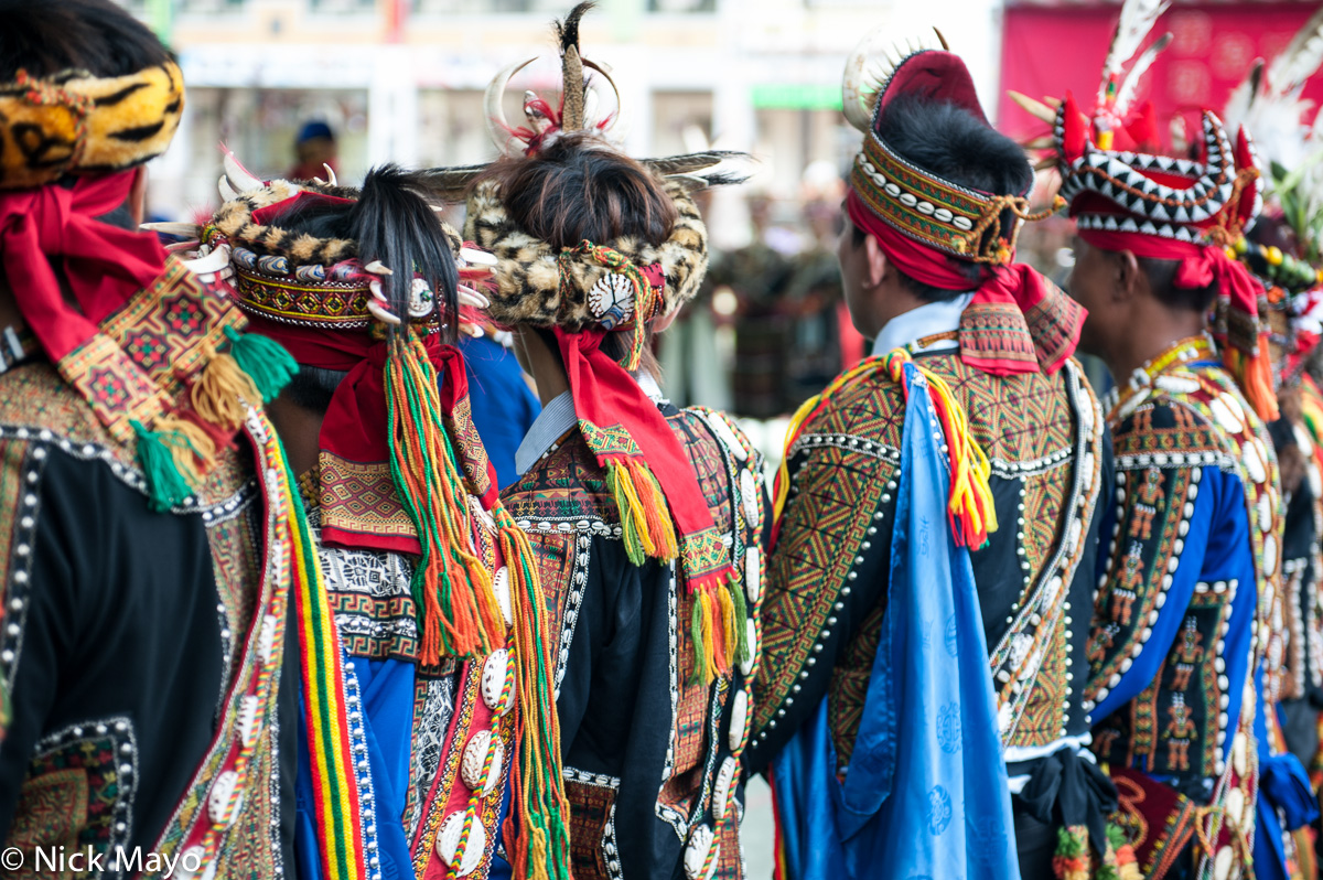 Rukai men in traditional clothes and hats at a post wedding dance in Wutai.