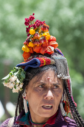 A Brokpa woman in a traditional headdress at a religious assembly in Lamayuru.