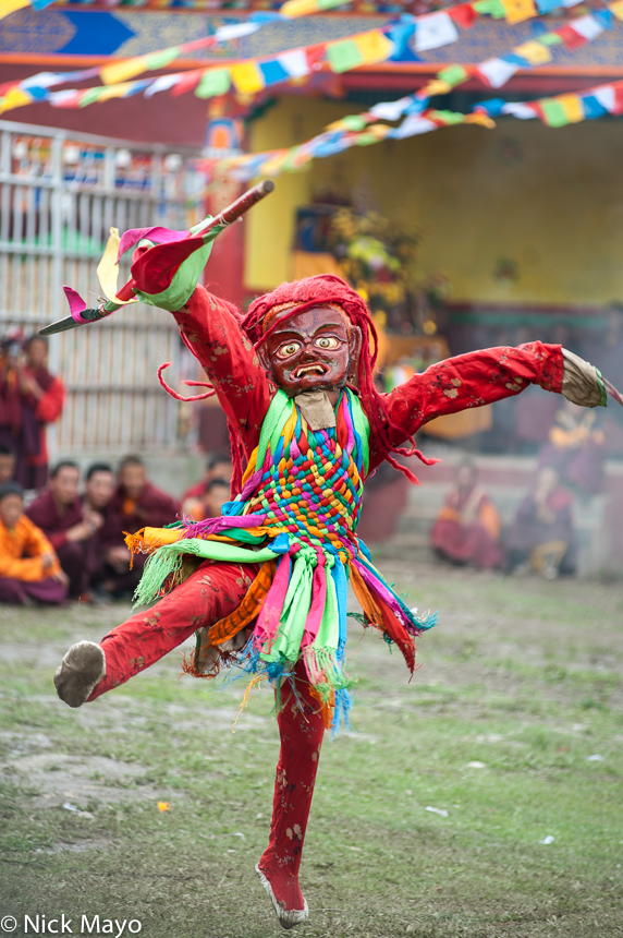 A masked monk dancing during a Tibetan festival at Manigango.