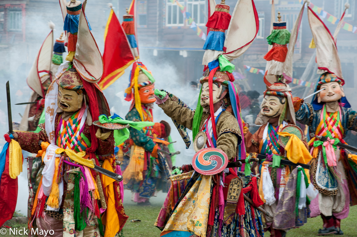 Masked monks dancing during a Tibetan festival at Manigango.