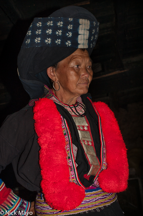 A Yao woman in traditional dress and hat in the village of Nonbu.
