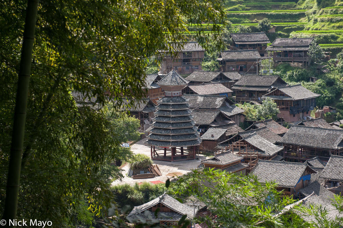 Wooden houses, with traditional grey tiled roofs, and a drum tower in the Dong village of Da Li.