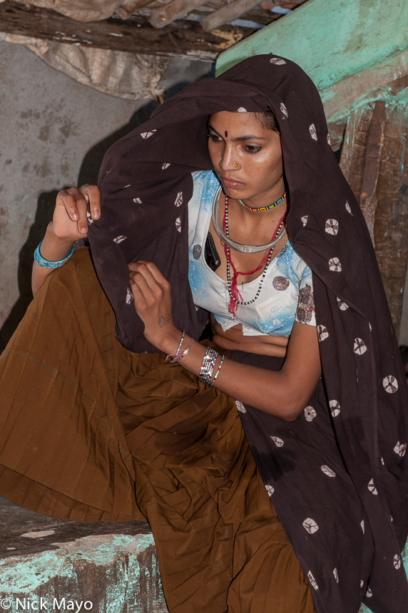 A beautiful Bhil Adivasi woman at a house near Poshina.