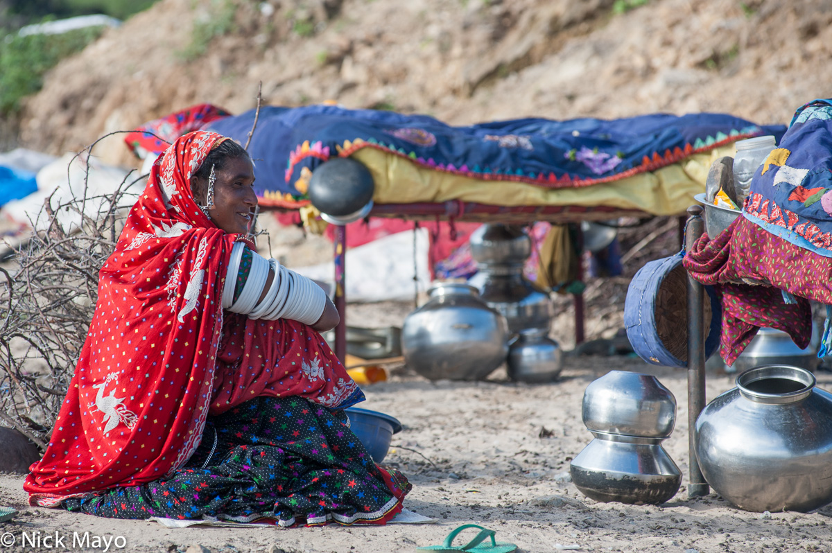 A Rabari woman, wearing a traditional headscarf and white arm bangles, at a campsite near Ambaji.
