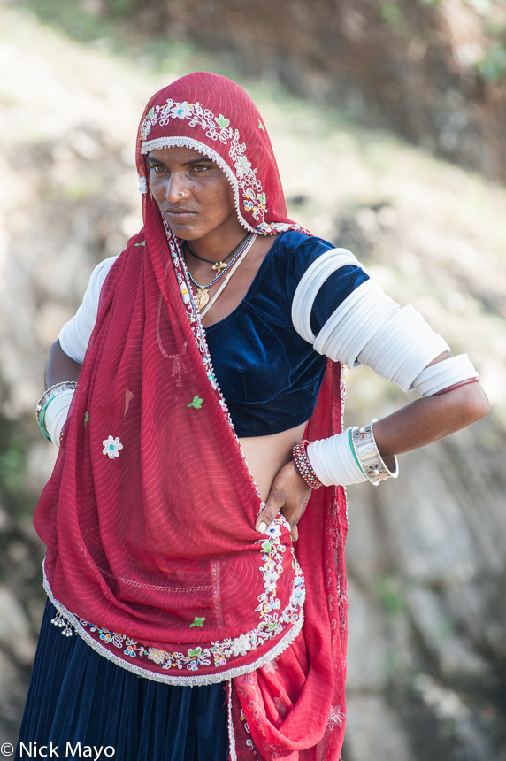 A Rabari woman, wearing a traditional headscarf, bracelets and white arm bangles, at a campsite near Ambaji.