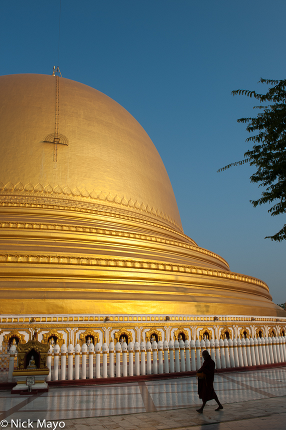 A monk making his morning round of the Kaunghmdaw pagoda in Sagaing.