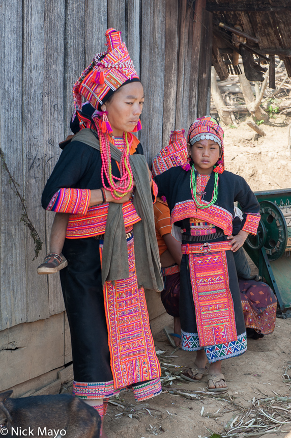 Loma from the village of Sbo traditionally dressed for their New Year in aprons, turbans, earrings and necklaces.