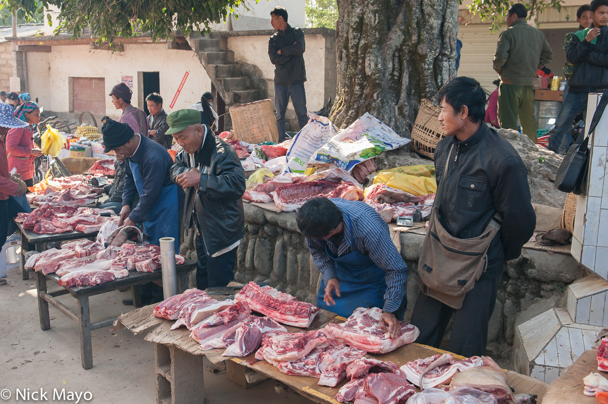 Vendors selling meat at the market in the Hani village of Jujie.
