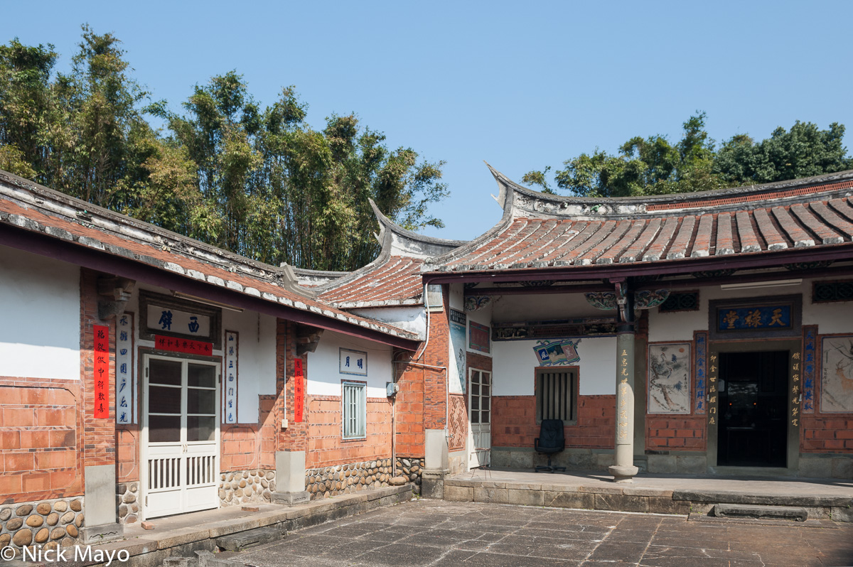 A traditional courtyard farmhouse near Xinpu with a swallow tail roof.