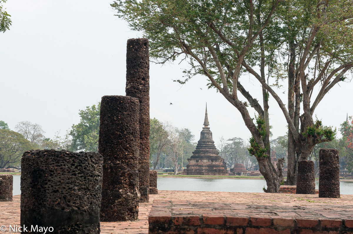 A stone and brick pagoda in the historical park of Old Sukhothai.