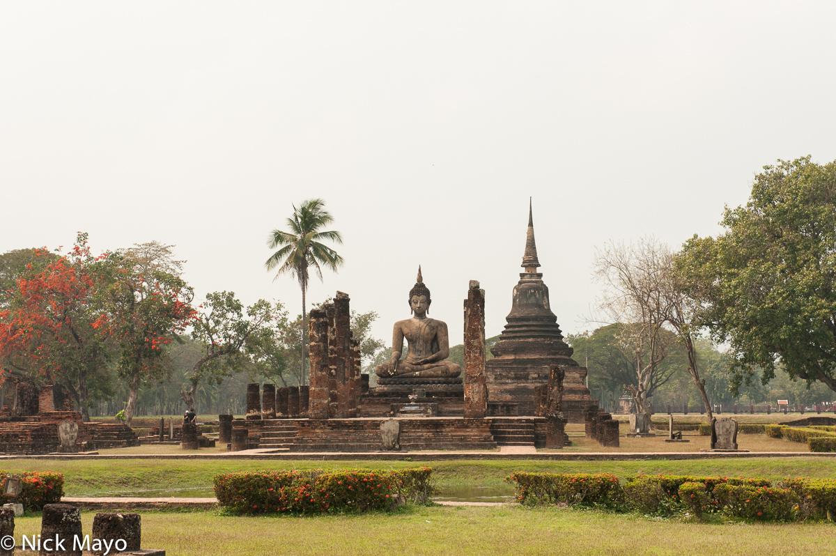 A seated buddha and pagoda at Old Sukhothai.