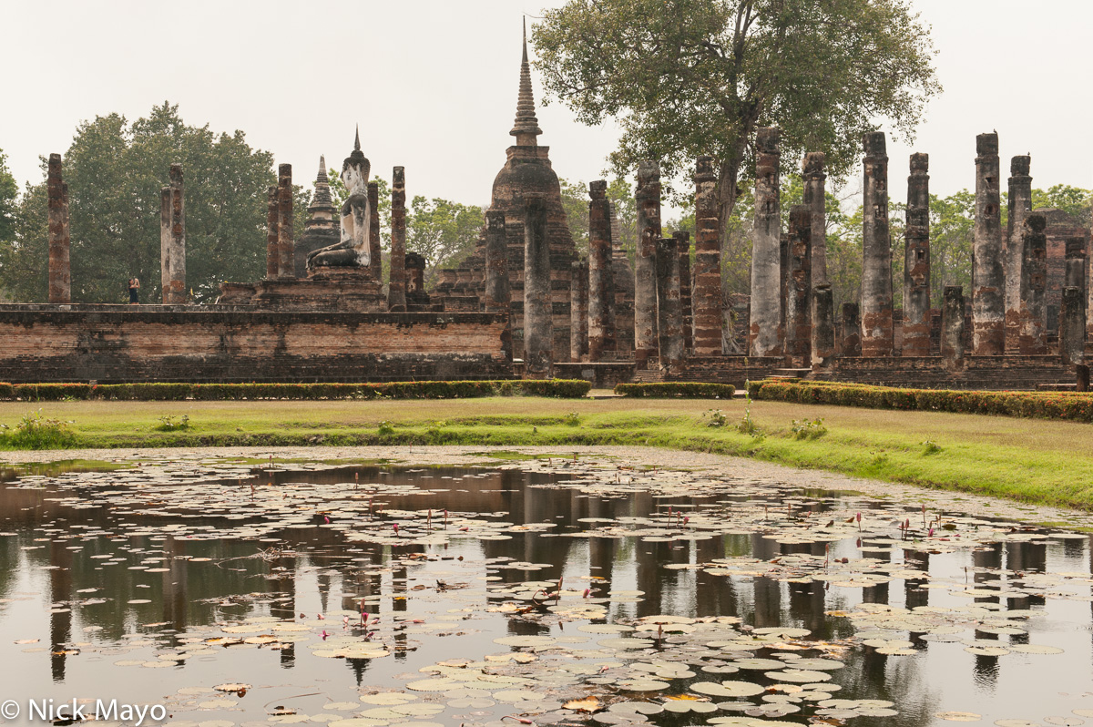 Reflection of the pillars and pagodas of Wat Mahathat at Old Sukhothai.