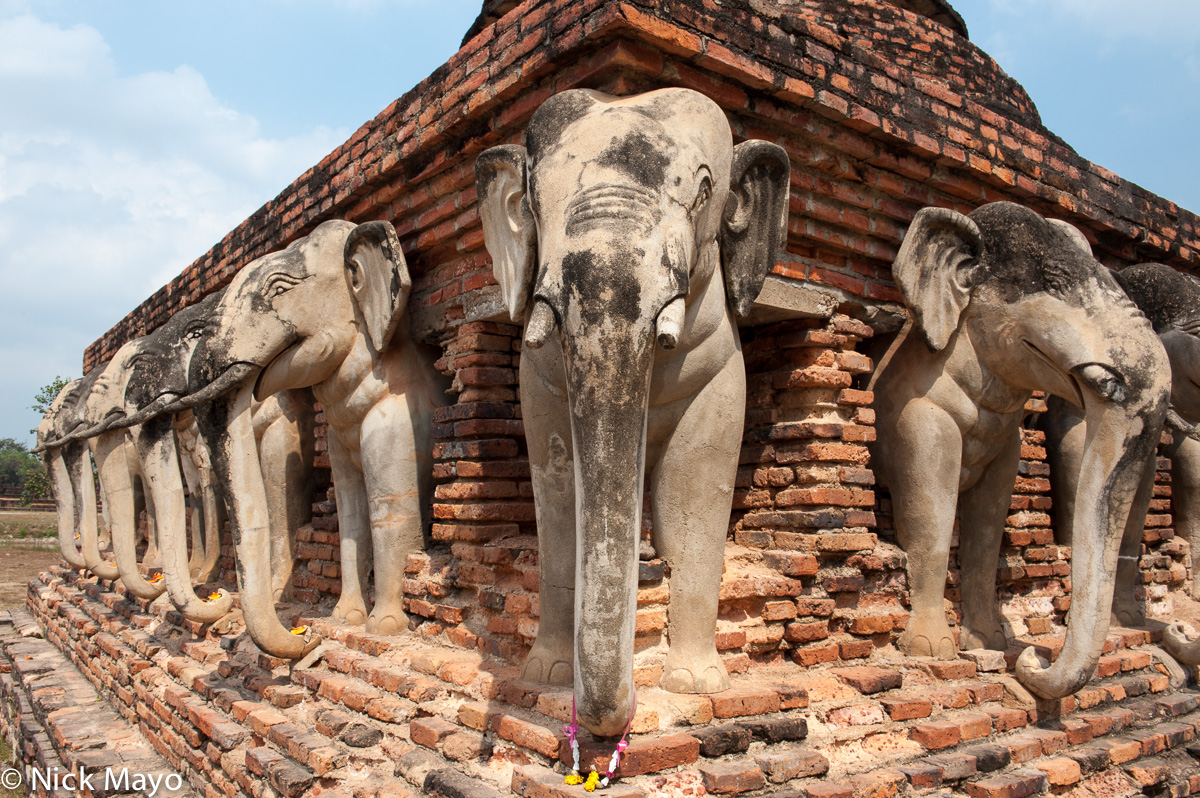 The stone elephant adorned plinth of the Wat Sorasak pagoda at Old Sukhothai.