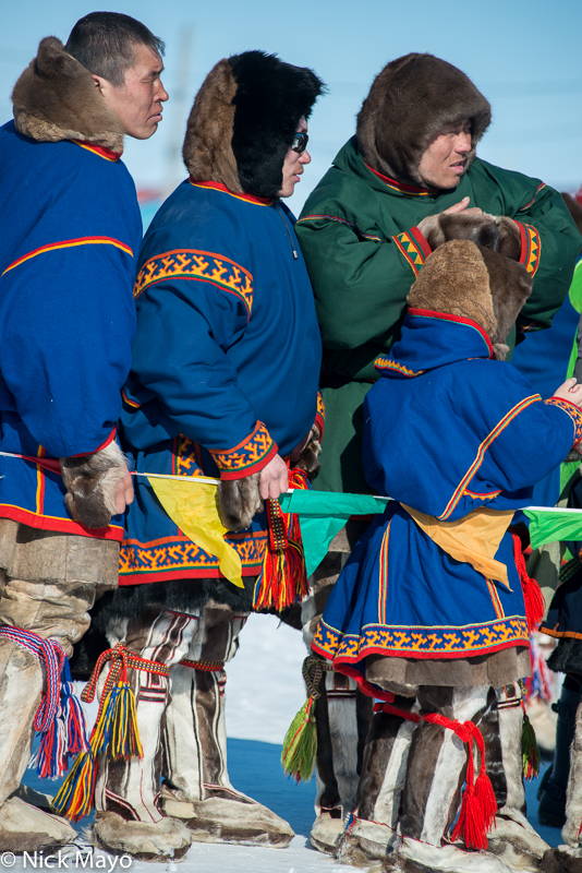 Nenets herders, dressed in their best malitsas and kisy (reindeer skin boots), at the Yar Sale festival on the Yamal peninsula...