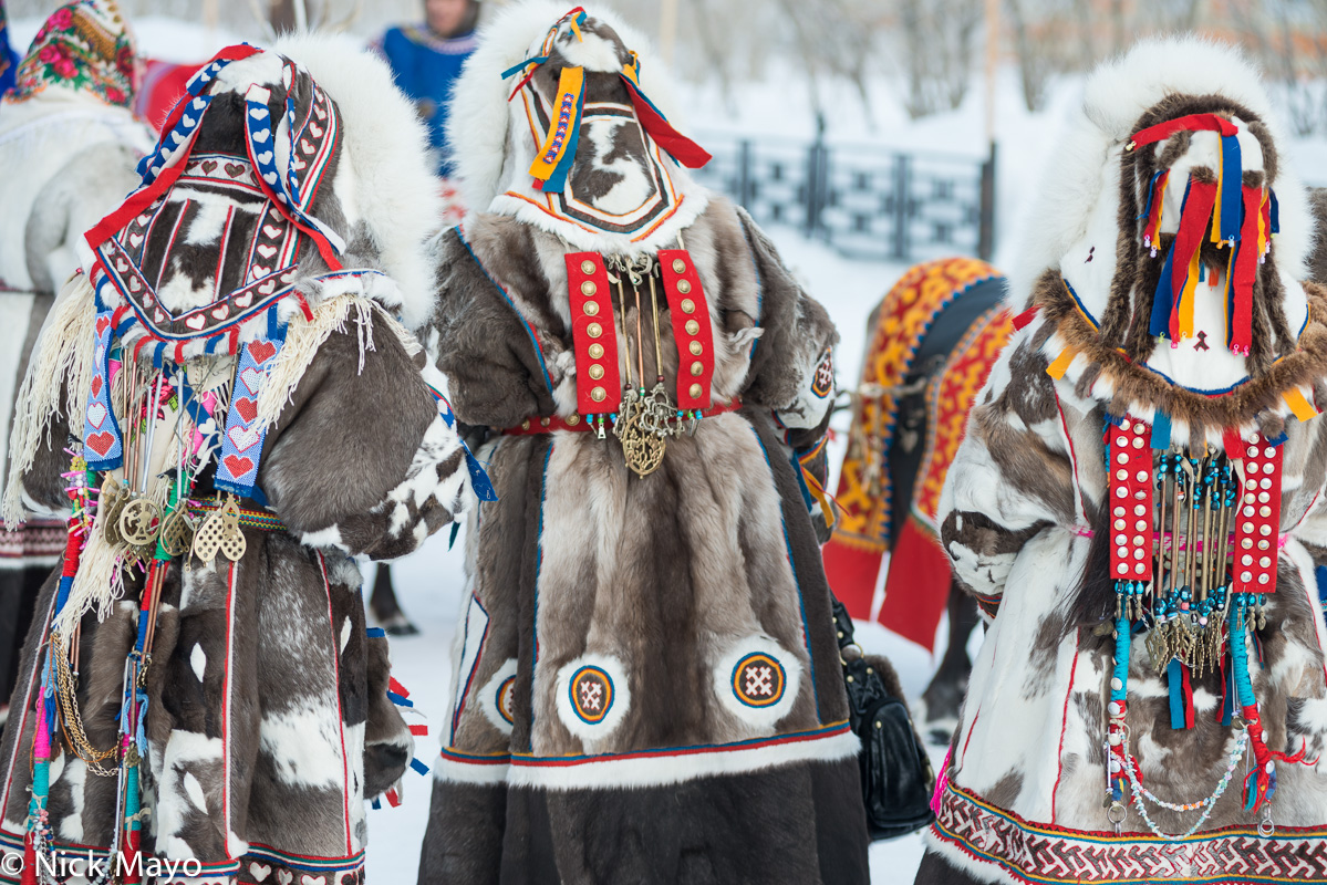 Decorative backpieces worn by three Nenets women over their yagushkas at a festival in Yar Sale on the Yamal peninsula.