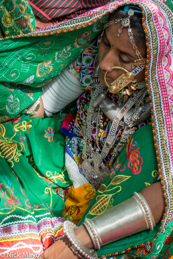 A Meghwal woman, wearing a head scarf, nose ring, necklace, white arm bangles and bracelets, at the Saang Wari fair in Ratanpar...