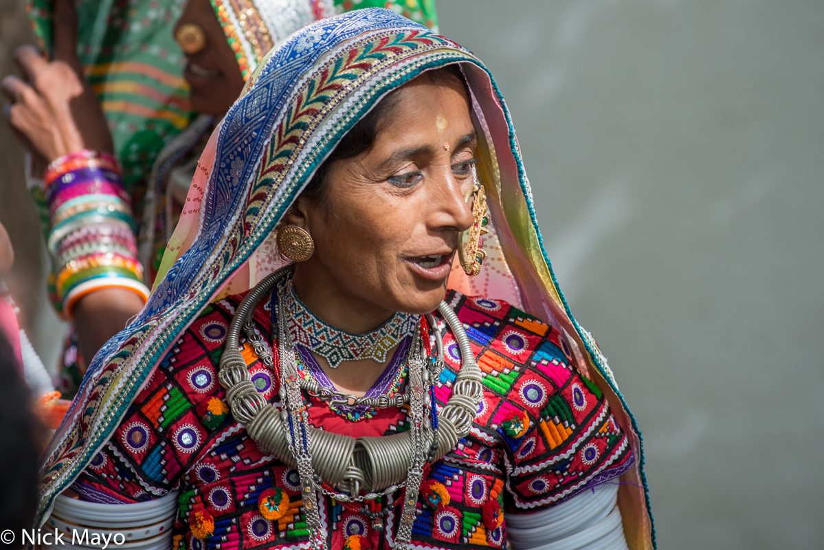 A Meghwal woman, wearing a head scarf, earrings, nose ring and heavy necklace, at the Saang Wari fair in Ratanpar, Kutch.