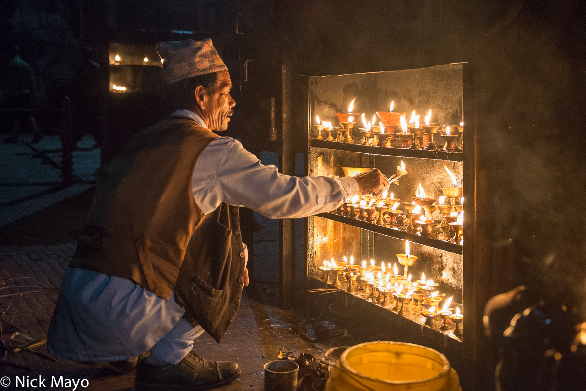 Replacing votive candles at Swayambhunath in Kathmandu.