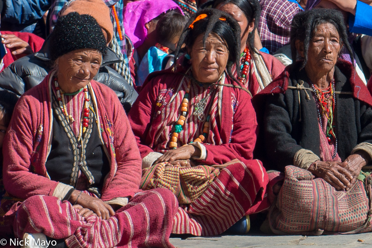 Three Monpa women watching the dancing at the Torgya festival in the Tawang monastery.