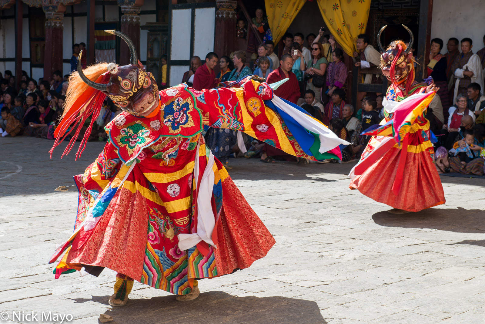 Two masked monks dancing at the tshechu in Trashigang dzong.