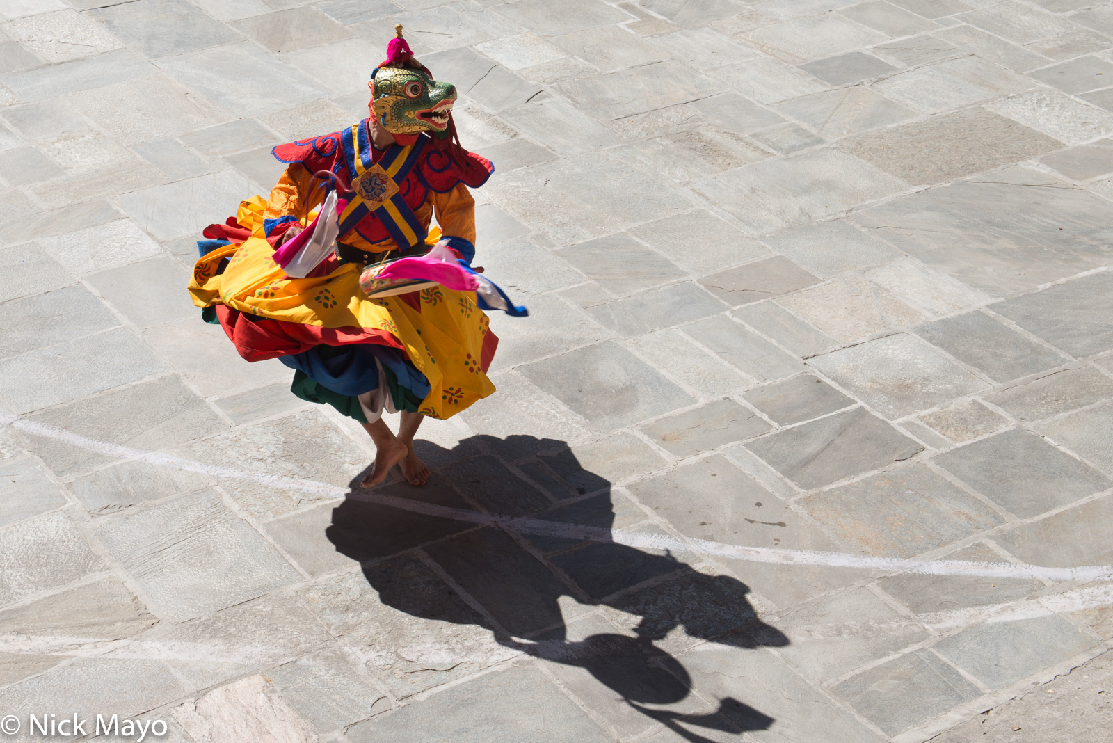 A masked monk performing a cham dance at the tshechu at Mongar.