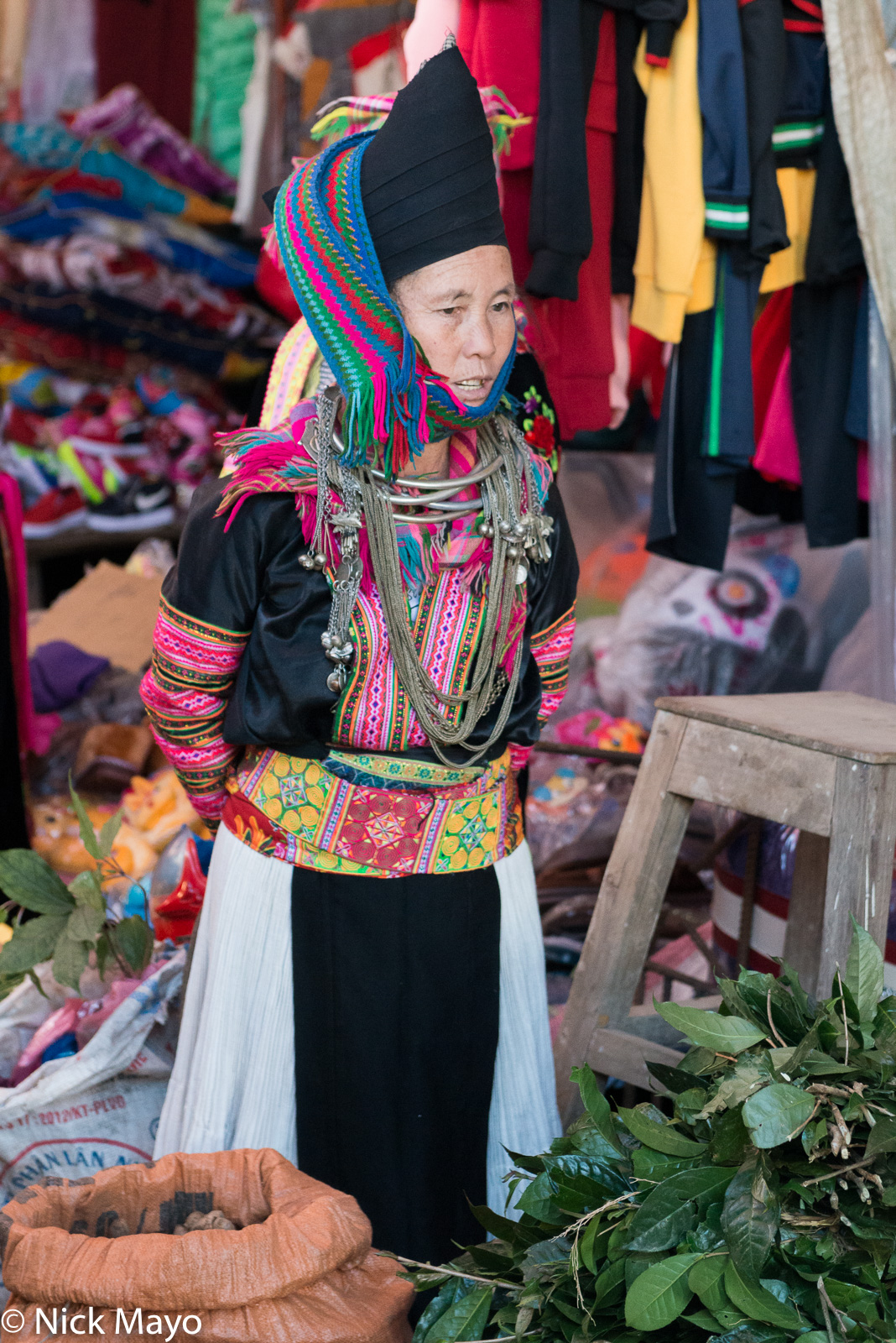 A White Hmong (Miao) woman selling vegetables in Sin Ho market.